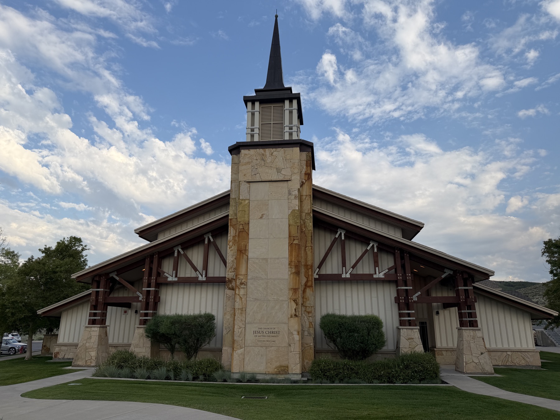The front of the Snyderville meetinghouse, with timber trusses and a sandstone tower under a blue sky